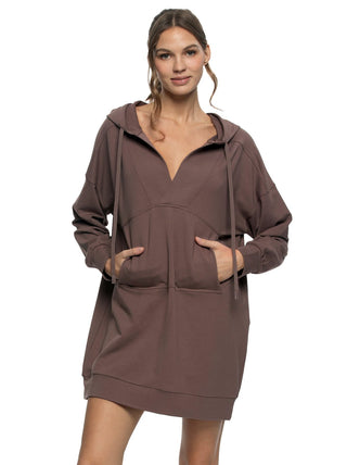 Woman wearing a brown hooded dress on a white background
